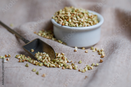 Tableau sur toile Fresh green buckwheat in a white porcelain cup on sacking