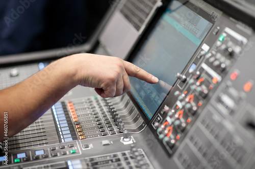 operator controls digital audio mixing console