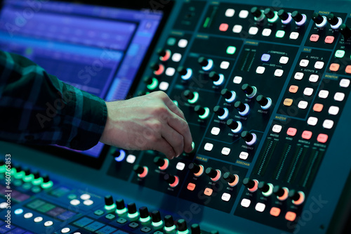 sound engineer controls digital mixing console