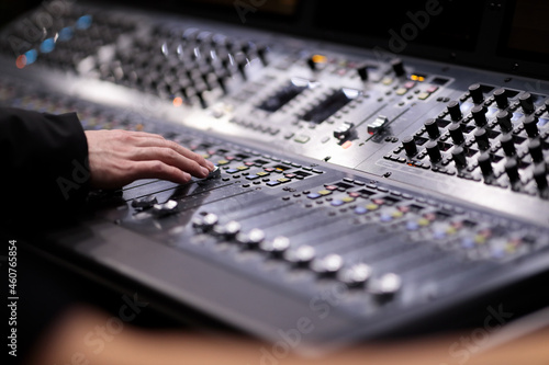 sound engineer working with audio mixing console