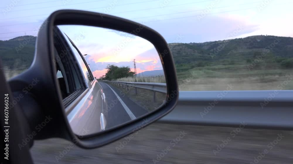 Driving by Rearview Mirror at Sunset, Road Traffic, Pov Tracking Car on Highway, Auto Window View Driving by Rearview Mirror at Sunset, Road Traffic, Pov Tracking Car on Highway, Auto Window View