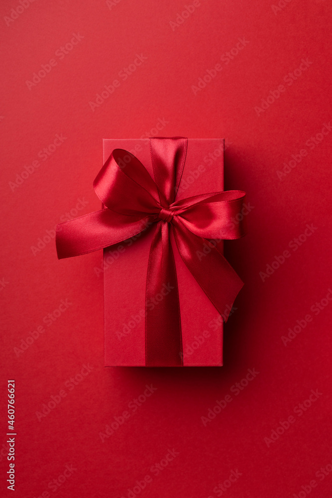 Top view on red gift box for Christmas or Valentine's day on red background . Top view on red gift box for Christmas or Valentine's day on red background .