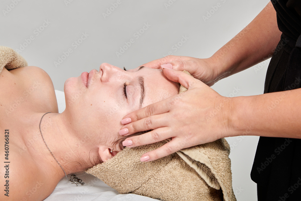 Professional masseuse massaging her female client Professional masseuse massaging her female client