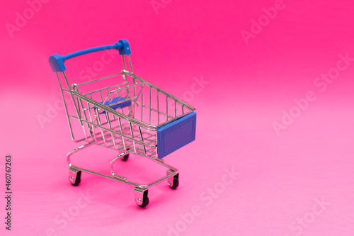 shopping cart isolated on pink background