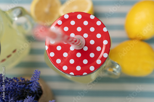 Mason jar top angle on a table with lemons on the side.