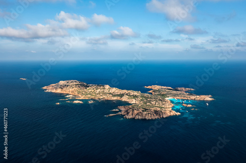View from above, aerial shot, stunning panoramic view of Mortorio island with a beautiful white sand beach and some boats and yachts floating on a turquoise, crystal clear water. Sardinia, Italy.