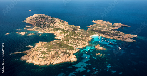 View from above, aerial shot, stunning panoramic view of Mortorio island with a beautiful white sand beach and some boats and yachts floating on a turquoise, crystal clear water. Sardinia, Italy. © Travel Wild