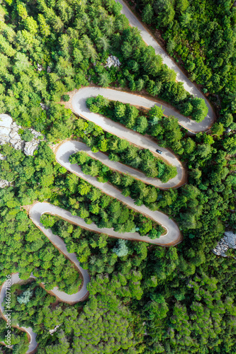 Obraz na płótnie View from above, stunning aerial view of a serpentine road surrounded by green pine trees. Mount Limbara (Monte Limbara) Sardinia, Italy w salonie