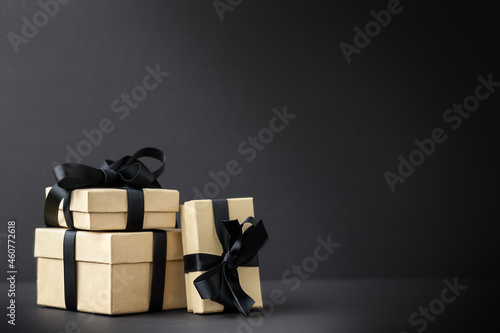 Black Friday background with gift boxes on black surface