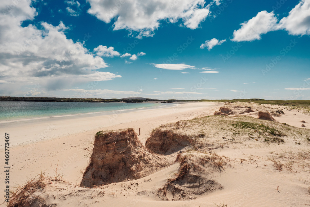 Sand dunes of Gurteen bay, county Galway, Ireland. Warm sandy beach with clear blue sky and water. Popular travel and holiday destination. Irish landscape. Nobody