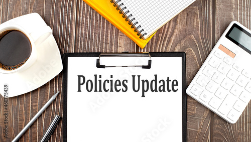 POLICIES UPDATE text on paper with coffee  calculator and notebook. Business concept
