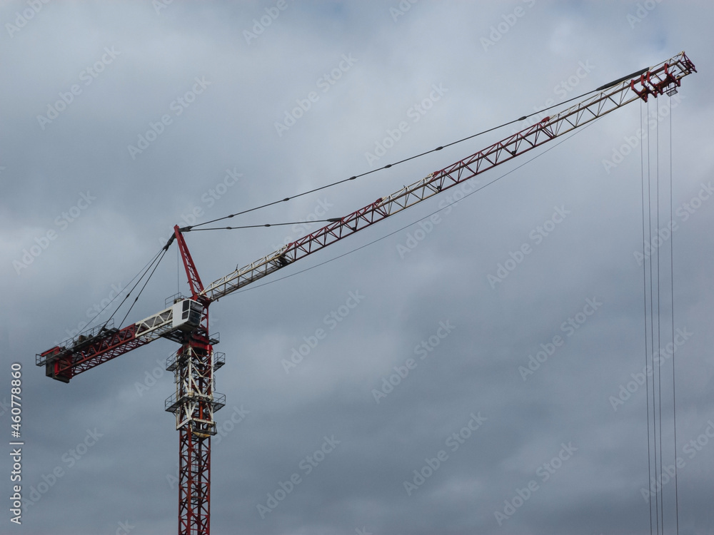 Modern tower crane on the background of the cloudy sky. Modern tower crane on the background of the cloudy sky.