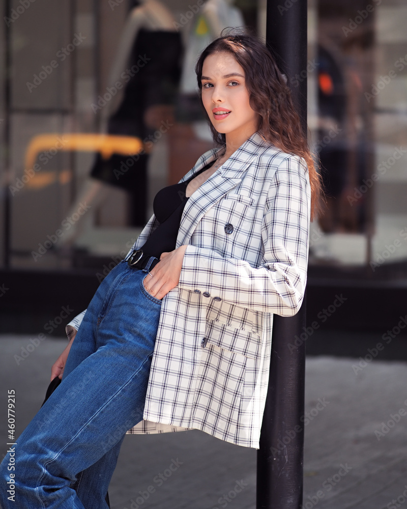 Woman in a jacket on the street with showcases