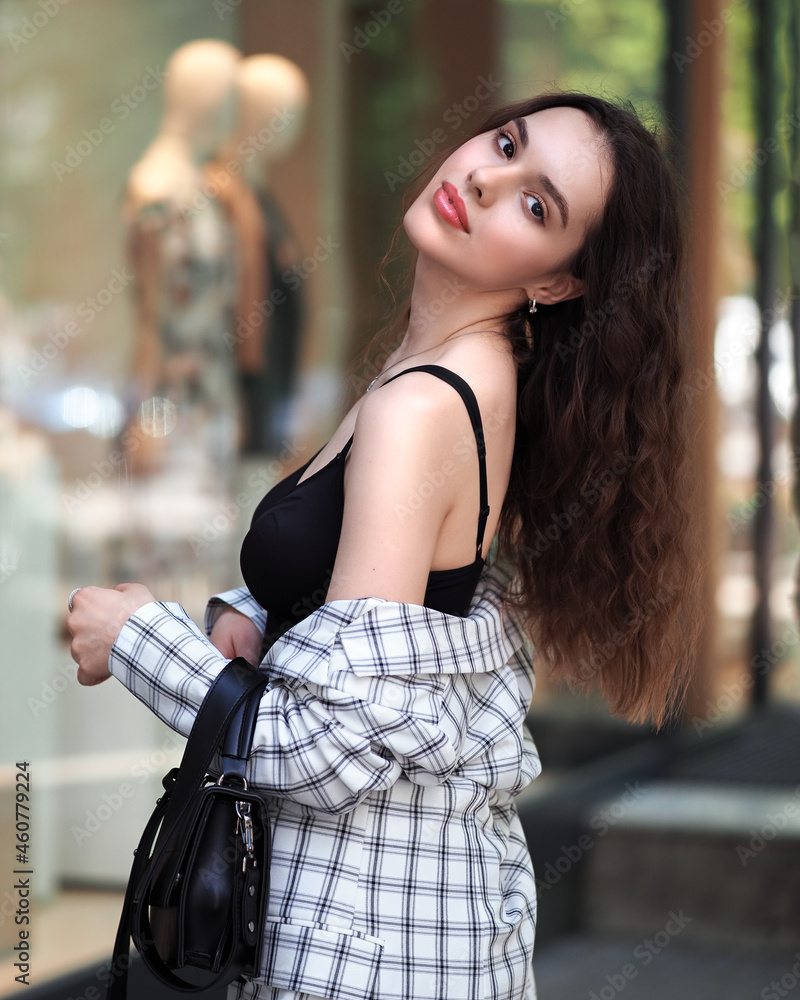 Woman in a jacket on the street with showcases