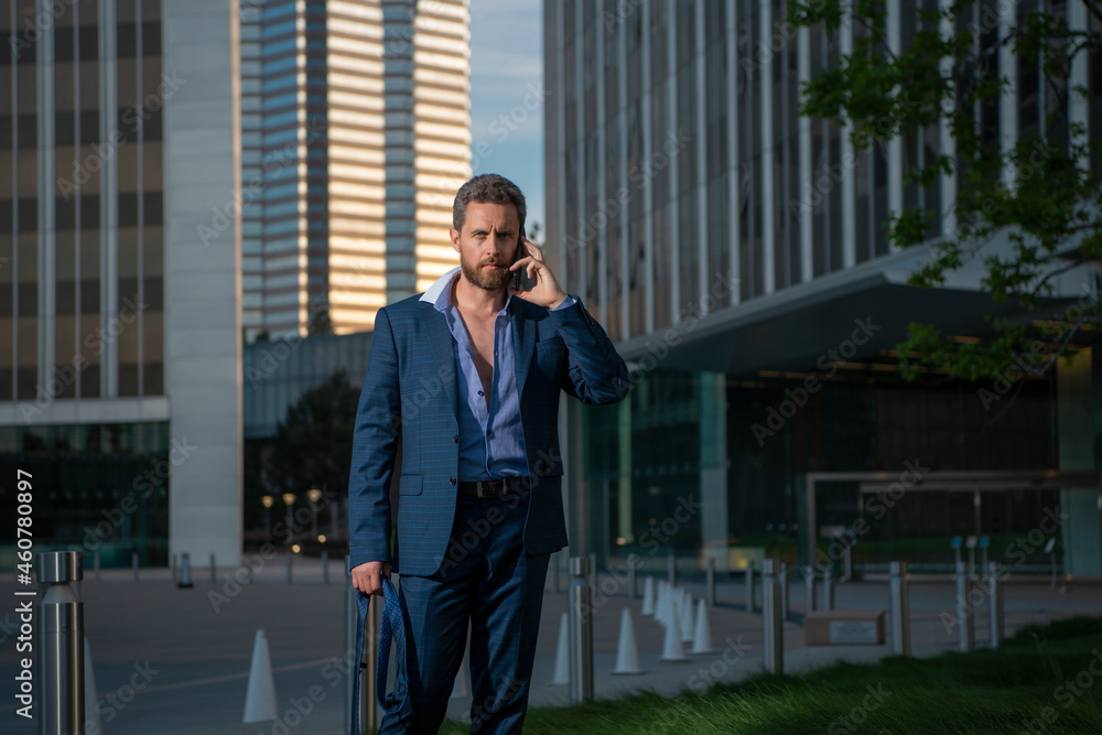 Caucasian business man in suit using smartphone. Sexy fashion businessman. Caucasian business man in suit using smartphone. Sexy fashion businessman.