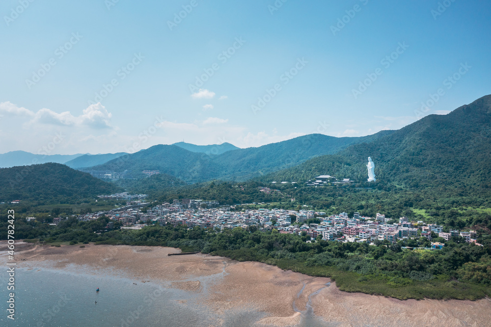 Giant Guanyin, Goddess Statue in countryside landscape of Tai Po, Hong Kong, daytime, clear day