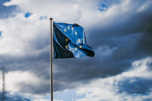 Flags - European Union against stormy sky