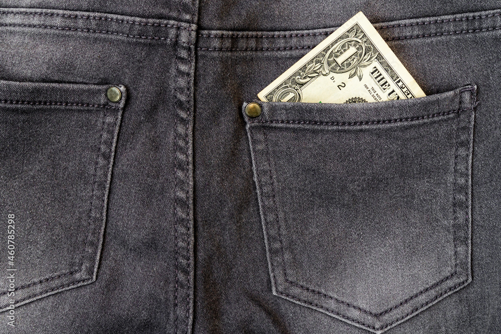 Dollar bills in jeans pocket close-up Dollar bills in jeans pocket close-up