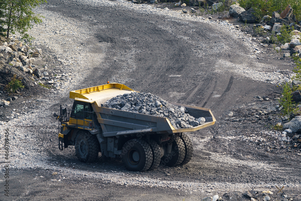 Obraz premium Dump truck in limestone mining, heavy machinery. Mining in the quarry.