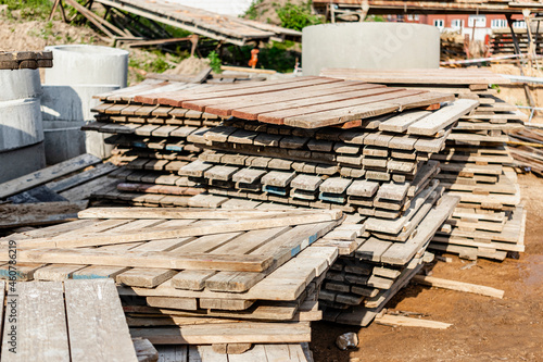Wooden pallets at a construction site. Reuse of building materials. Paving tool. photo
