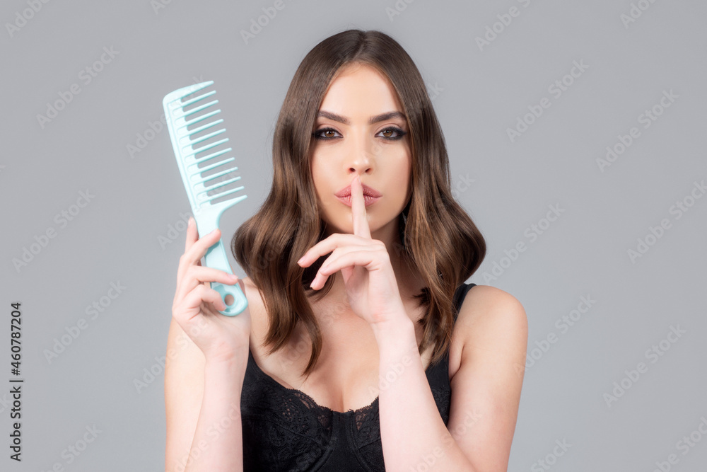 Portrait of charming brunette hair lady combing hair with hairbrush comb, isolated. Young beautiful woman brush long healthy brunette hair, classic hairstyle, restoration mask, haircare concept.