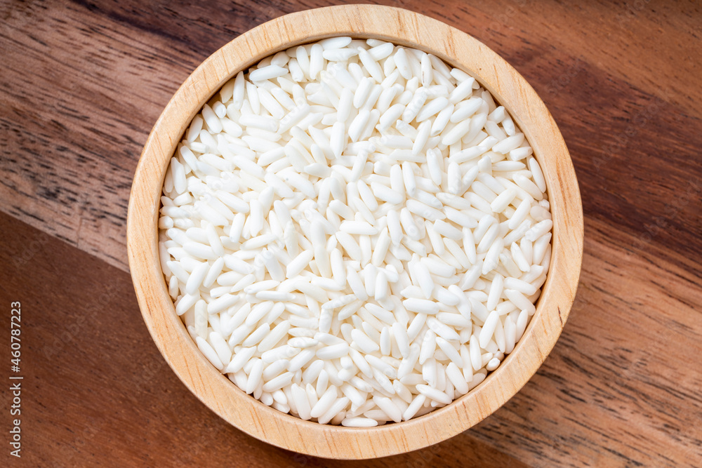 Rice grains in wooden bowl on wooden background, Jasmine rice grains in wooden bowl on wooden background. Rice grains in wooden bowl on wooden background, Jasmine rice grains in wooden bowl on wooden background.