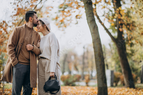 Young couple together in an autumn park