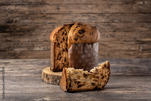 Traditional Italian panettone for Christmas on rustic wooden table photo