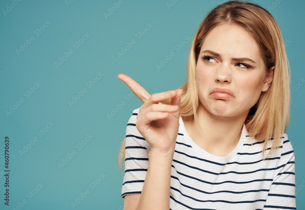 emotional woman in a striped t-shirt gesturing with her hands serious look