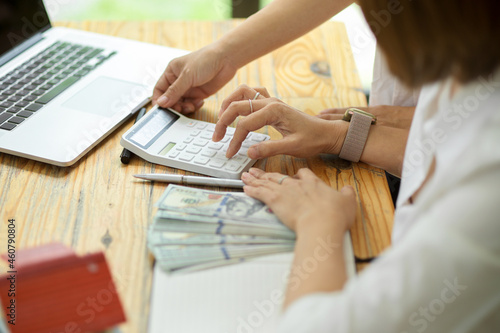 Business female entrepreneur calculating money on calculator