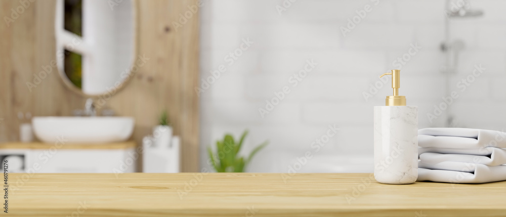 Wooden table top with ceramic shampoo bottle and towels over bathroom interior background - obrazy, fototapety, plakaty 
