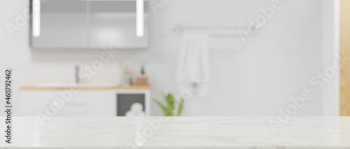 Copy space on marble tabletop for montage white blurred modern contemporary bright bathroom