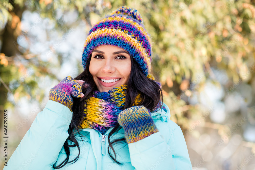 Photo of positive charming lady shiny white smile wear knitted mittens hat scarf coat in park outdoors Photo of positive charming lady shiny white smile wear knitted mittens hat scarf coat in park outdoors
