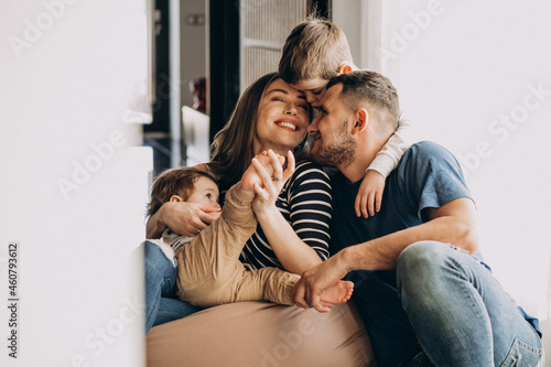 Young family with their sons at home having fun photo