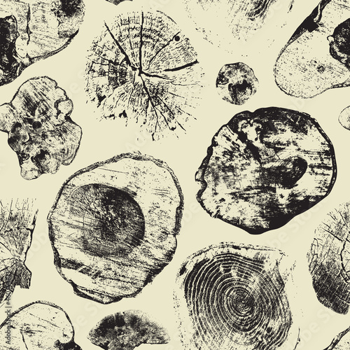 Abstract seamless pattern with sawn tree trunks on a light backdrop in retro style. Monochrome vector background with stumps of various shapes. Wooden texture with cross sections of old trees