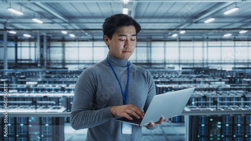 Wallpaper Mural Portrait of a Data Center Engineer Using Laptop Computer. Server Room Specialist Facility with Korean Male System Administrator Working with Data Protection Network for Cyber Security. Torontodigital.ca