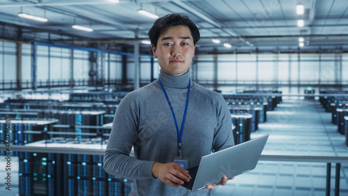 Fényképezés Portrait of a Data Center Engineer Using Laptop Computer