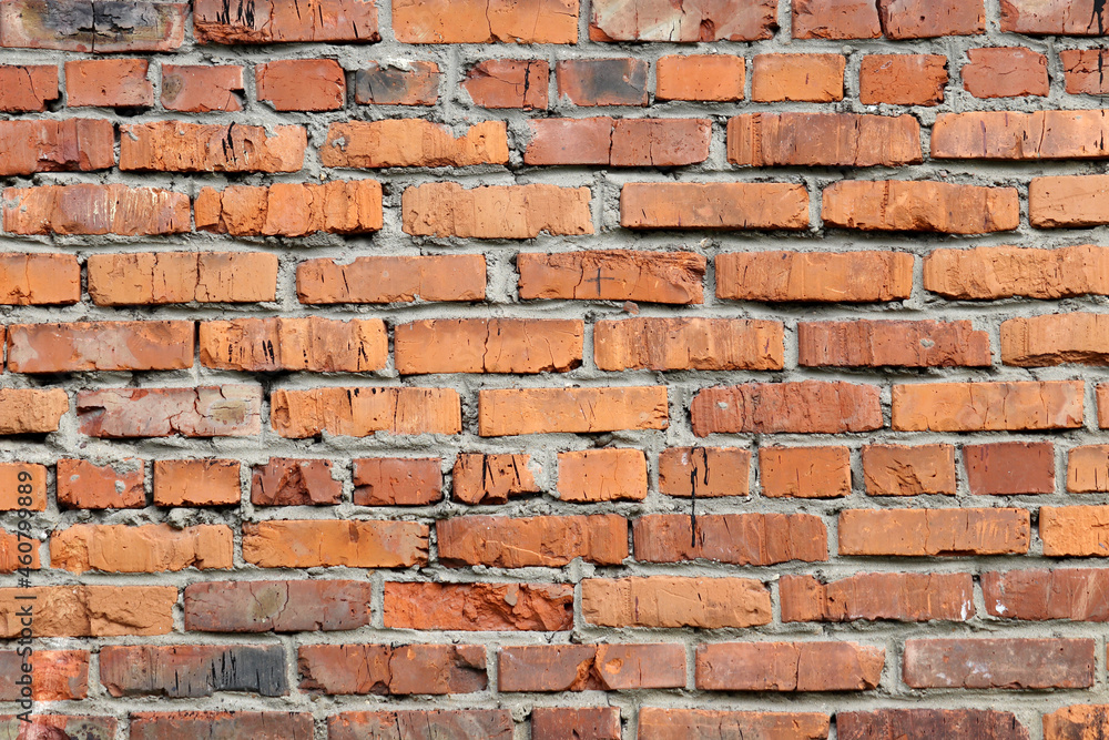 Red brick wall texture. Old facade of a building with concrete joints, vintage background Red brick wall texture. Old facade of a building with concrete joints, vintage background