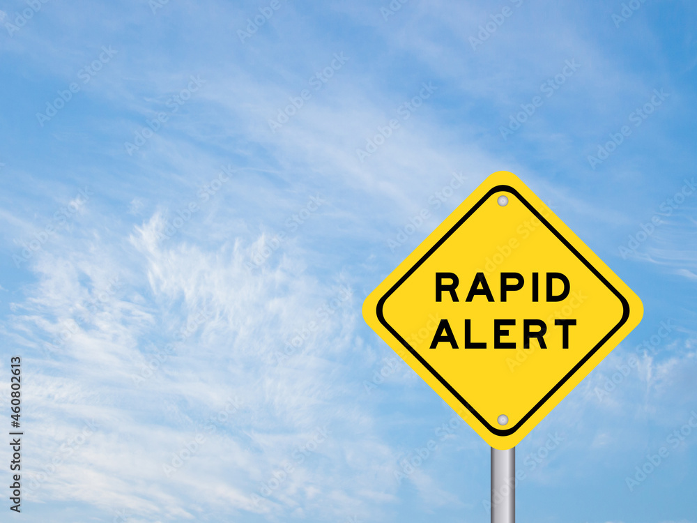 Naklejka premium Yellow color transportation sign with word rapid alert on blue sky background