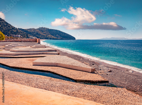 Empty publik beach of Dhermi town. Splendid morning seascape of Adriatic sea with Corfu island on background. Stunning spring scene of Albania, Europe.