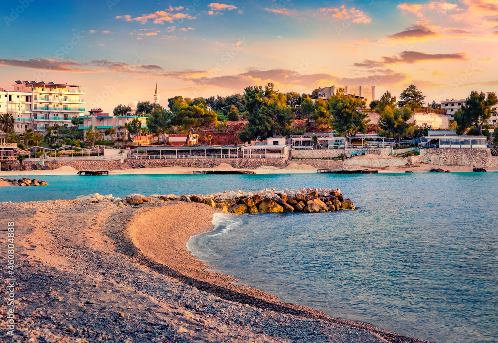 Attractive summer cityscape of Ksamil port. Spectacular evening seascape if Ionian sea. Captivating sunset in Butrint National Park, Albania, Europe. Traveling concept background.