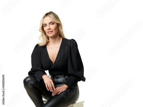 business woman seated on a stool on a white background.