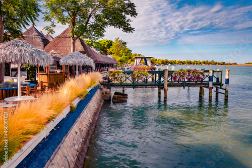 Sunny morning view of Bibione Pineda village, Metropolitan City of Venice, Italy, Europe. Splendid summer scene of Laguna. Traveling concept background.. photo