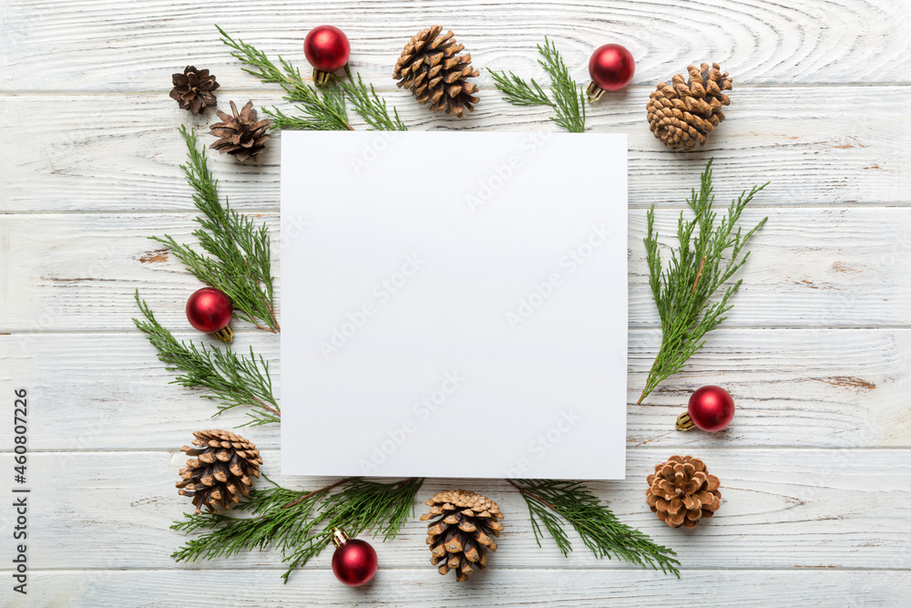 Flat lay Christmas composition. square Paper blank, pine tree branches, christmas decorations on Colored background. Top view, copy space for text Flat lay Christmas composition. square Paper blank, pine tree branches, christmas decorations on Colored background. Top view, copy space for text