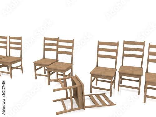 Row of wooden chairs with an upturned chair in the foreground