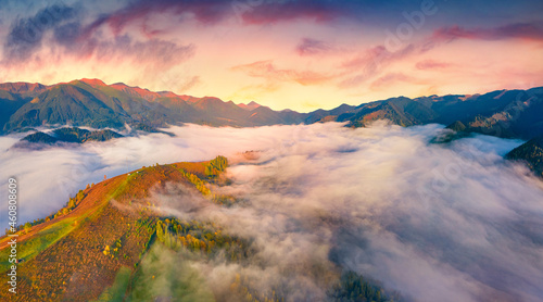 Foggy sunrise in Stebnyi village outskirts. Fantastic summer view from flying drone of Carpathian mountains, Ukraine, Europe. Beauty of nature concept background.