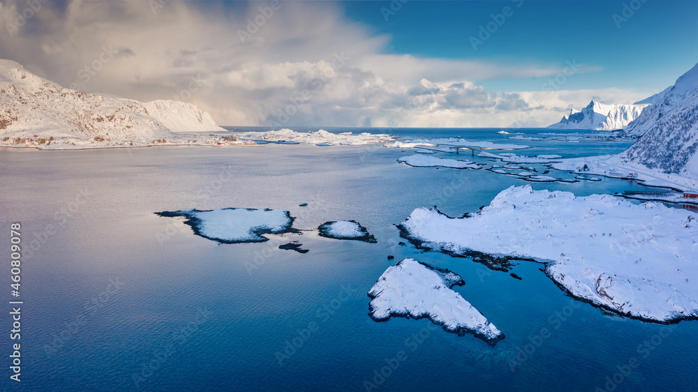 Frosty morning view from flying drone of Kubbholmsundet fjord with Fredvang bridge on background. Beautiful winter seascape of Norwegian sea, Lofoten Islands,  Norway, Europe.