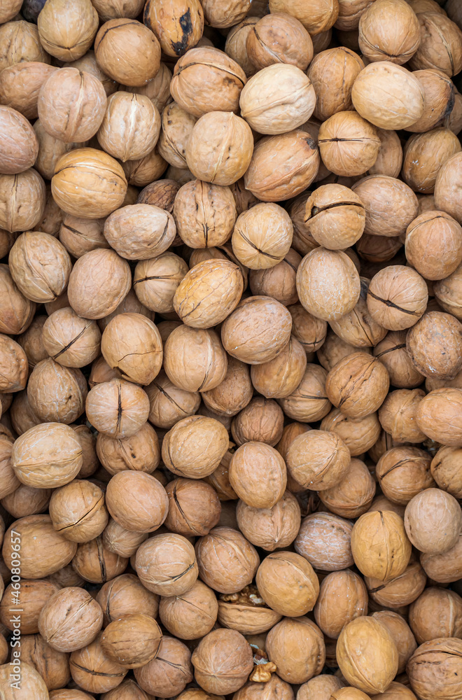 Textured surface made from unshelled walnuts. Delicious and healthy food. Textured surface made from unshelled walnuts. Delicious and healthy food.