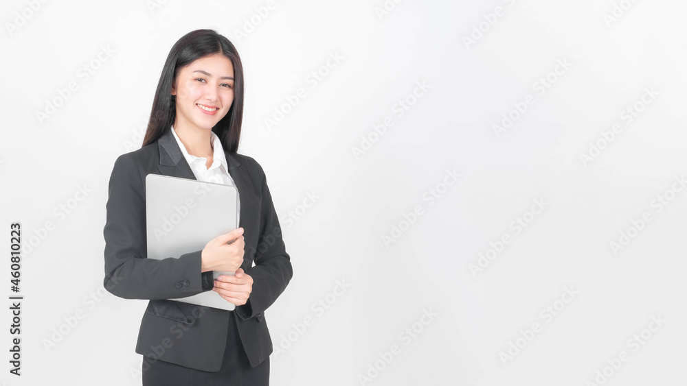 lifestyle business woman , beautiful Asian cute girl wear a business suit holding laptop computer isolated on white background with copy space , business concept. lifestyle business woman , beautiful Asian cute girl wear a business suit holding laptop computer isolated on white background with copy space , business concept.