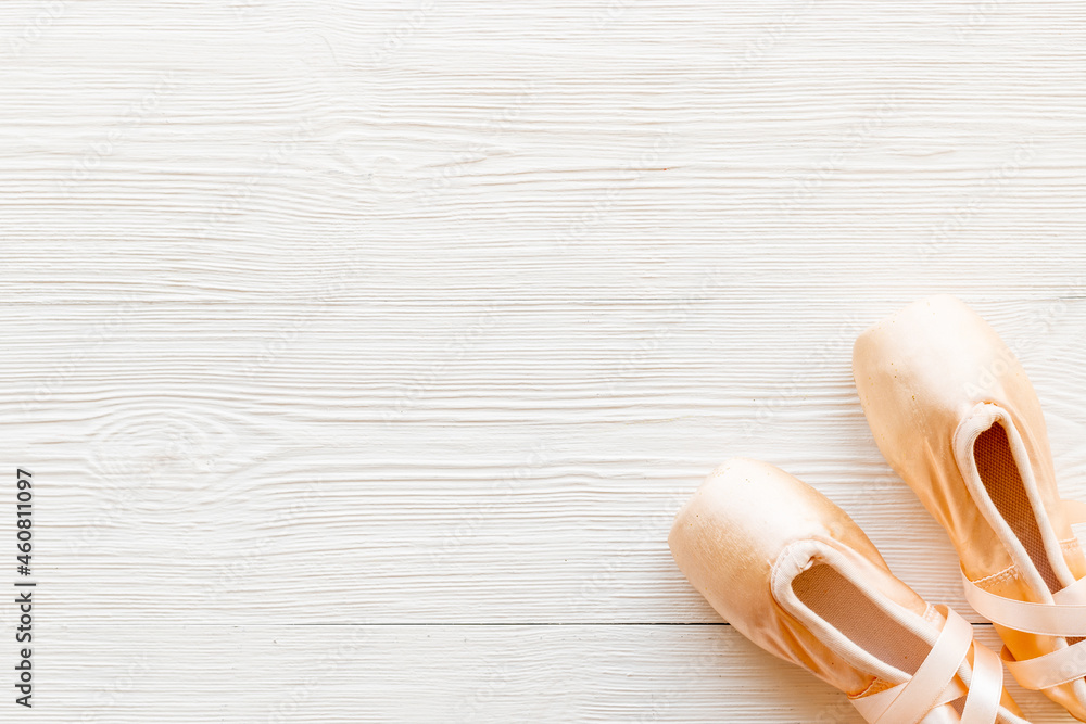 Pair of beige ballet pointe shoes with ribbon, top view Pair of beige ballet pointe shoes with ribbon, top view